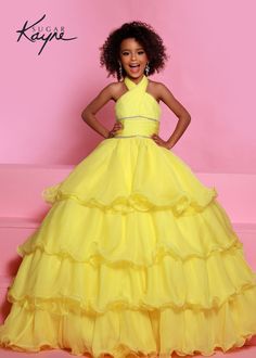 Sugar Kayne C305 Girls and Preteens Ruffle Pageant Ball Gown Cape Halter Formal DressOh s'cute!! This poly chiffon layered ballgown features a crisscross halter neckline with beaded trim along the waist. The train will float seamlessly across the stage, especially with the detachable cape. Oh s'cute!! This poly chiffon layered ballgown features a crisscross halter neckline with beaded trim along the waist. The train will float seamlessly across the stage, especially with the detachable cape.Colo Gown Cape, Detachable Cape, Johnathan Kayne, Sleeveless Chiffon Dress, Mnm Couture, Jasz Couture, Plastic Dress, Chiffon Fashion, Pageant Dress