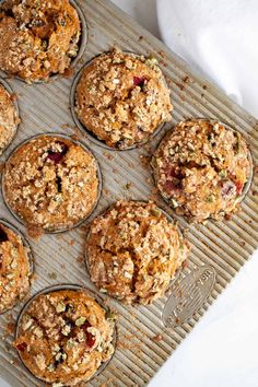 muffins with crumbled toppings on a cooling rack, ready to be baked