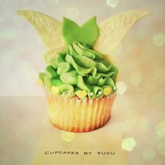 a cupcake decorated with green icing and leaves