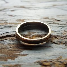 "To create this humble, minimalist band, I start with thick, solid 14k gold wire that I join to form a perfect circle, then hammer for a subtle texture. This band is hand polished for high shine, but can also be made with a matte finish upon request (select color and finish from drop down menu at checkout). Each band measures just over 3mm wide and 1.5mm thick, and is joined with 14k cadmium free, color match, plumb-gold solder to ensure a seamless join and the highest possible gold content. Rin Simple Yellow Gold Jewelry With Smooth Bezel, Minimalist Hammered Yellow Gold Rings, Simple Hammered 14k Gold Rings, Minimalist Hammered Round Band Ring, Simple Recycled Gold Rings For Anniversary, Hand Forged 14k Gold Stackable Rings With Round Band, Hand Forged Stackable 14k Gold Rings With Round Band, Classic Hand Forged Stackable Rings For Promise, Minimalist Hand Forged Anniversary Ring