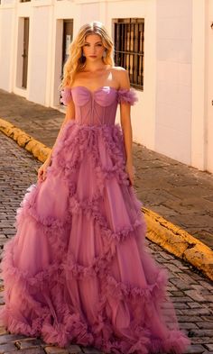 Here's an off-the-shoulder long lavender prom ball gown that is as flirty as it is feminine. With a sheer corset-style bodice that wraps around to the back and ruffled banded sleeves that drape over the upper arms, this long lavender formal dress was made for romance. In misses and some plus sizes, this sweet long evening gown has a fully-lined long skirt with ruffled geometric designs that showcase a real southern feel. A look of romance with a southern feel, this off-the-shoulder long lavender Summer Ball Gown, Ballgown Prom Dress Corset, Ball Gown For Prom, Lavender Formal Dress, Prom Dress With Corset, Long Ball Gown, Sheer Corset, Dusty Lavender, Corset Boning