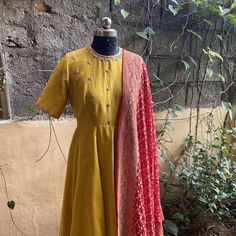 Hand embroidered yellow Anarkali with red banarasi bandhej dupatta / anarkali suit set / anarkali dupatta USA / khaddi georgette dupatta / Indian dresses/ voggish / yellow  anarkali dress          Looking for a perfect indian dress/anarkali/suit sets that are trendy, unique and easy to carry !! yess, You are at the right place. we carry such versatile pieces of anarkalis and suit sets that really let you stand out in any occassion !!      featuring this beautiful pure chanderi dress in mustard y Yellow Raw Silk Unstitched Suit With Straight Kurta, Festive Yellow Cotton Silk Salwar Kameez, Yellow Chanderi Unstitched Suit For Festivals, Yellow Silk Churidar With Zari Work, Anarkali Unstitched Suit For Celebration With Pallu, Anarkali Sets With Zari Weaving For Celebrations, Traditional Yellow Silk Churidar, Anarkali Celebration Sets With Zari Weaving, Designer Yellow Unstitched Suit With Dupatta