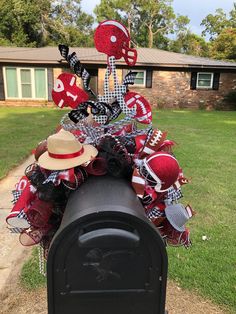 a mailbox decorated with footballs and hats