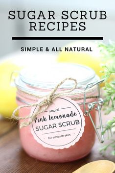 a pink lemonade sugar scrub in a jar with a wooden spoon