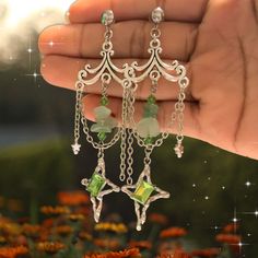 ✨"Elevate your style with our Silver Chandelier Earrings, each pair a unique and magical creation! ✨  These stunning earrings feature intricate silver designs adorned with colorful accents, making every pair one-of-a-kind. The elegant chandeliers catch the light beautifully, adding a touch of whimsy and sophistication to any outfit. Whether you're dressing up for a special occasion or adding a dash of magic to your everyday look, these earrings are sure to turn heads. Embrace the enchanting allu Silver Fantasy Dangle Jewelry, Silver Chandelier Earrings With Dangling Charms As Gift, Silver Fantasy Pierced Earrings, Pierced Silver Fantasy Earrings, Silver Dangle Fantasy Earrings, Chandelier Dangle Earrings With Dangling Charms For Gift, Gift Chandelier Dangle Earrings With Charms, Metal Chandelier Earrings With Dangling Charms As Gift, Mystical Dangle Earrings In Sterling Silver