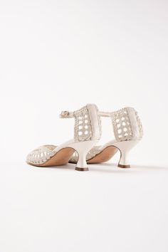 A true totem for the brand, the Veronica is reissued this season. It's made of hand-woven leather, emblematic of Spain and the signature of Souliers Martinez. Its square neckline perfectly hugs the curves of the foot, ensuring incomparable comfort. Its small 5.5 cm heel subtly elongates the silhouette without compromising comfort. Heel: 5.5 cm Elegant Sandals With Ankle Strap And Woven Sole, Elegant Ankle Strap Sandals With Woven Sole, Elegant Evening Sandals In Woven Leather, Elegant Woven Leather Sandals For Evening, Elegant Evening Sandals With Woven Leather, Elegant Closed Toe Sandals With Woven Sole, Elegant Sandals With Woven Sole, Elegant Woven Leather Heels With Open Heel, Elegant Woven Leather Sandals With Ankle Strap