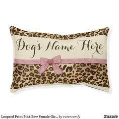 a leopard print pillow with a pink ribbon on the front and dog's name here