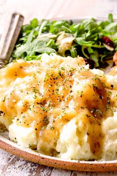 mashed potatoes with gravy and greens on a plate