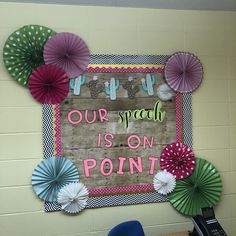 a bulletin board with paper fans on it and a sign that says our speech is on point