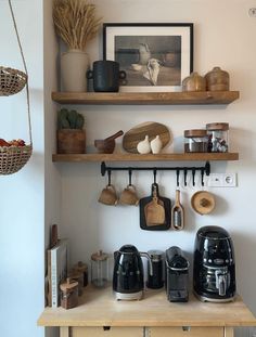 the shelves are filled with coffee pots and other kitchen items