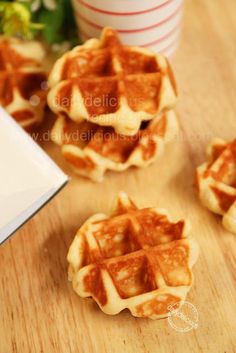 some waffles are sitting on a table next to a cup