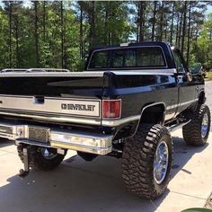 the truck is parked in the driveway with its flat bed on it's wheels