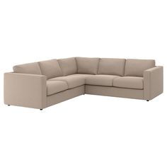 a beige sectional couch sitting on top of a white floor