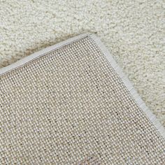 an area rug that has been placed on the floor with a piece of cloth next to it