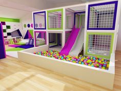 an indoor play area with balls and slides