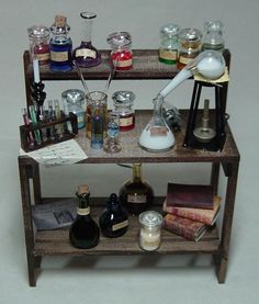 a shelf filled with bottles and candles on top of a table