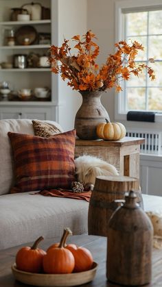 a living room filled with furniture and lots of pumpkins on top of a table