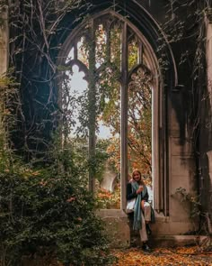 a woman is sitting in an old building