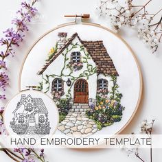 a cross stitch pattern with a house in the middle and flowers around it on a white background