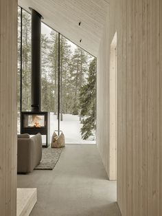 a living room with a fireplace and large windows