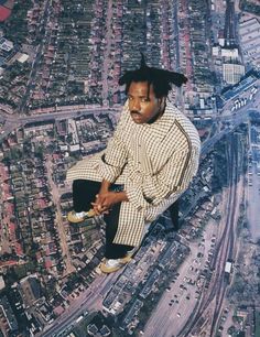 a man sitting on top of a tall building