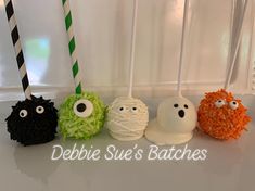 four halloween cake pops decorated with sprinkles and eyes