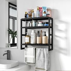 a bathroom shelf filled with lots of personal care items next to a sink and window