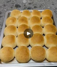 a pan filled with rolls sitting on top of a counter next to a video player