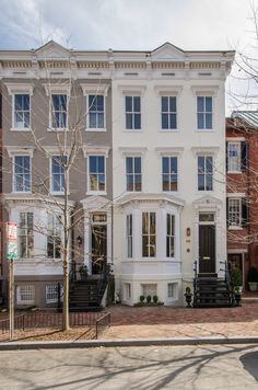 a white two story building with many windows