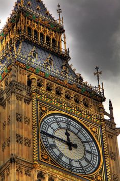 the big ben clock tower towering over the city of london, england on a cloudy day