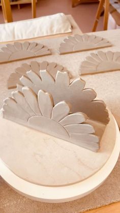 a table topped with white trays filled with cake