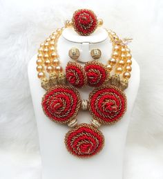 Beautiful Red Gold New Latest Design African Red Beads Bridal Wedding Jewelry Necklace Set Beads can be customised to your specification and color Comes with Necklace, earring and bracelet Comes with 2 styles of earring Traditional Red Beads With Bead Caps, Red Polished Beads Jewelry Sets, Festive Red Polished Bead Jewelry Sets, Red Jewelry Sets With Polished Round Beads, Red Jewelry Sets With Round Beads For Gift, Festive Red Jewelry Sets With Polished Beads, Elegant Red Beads For Wedding, Elegant Red Beaded Bridal Necklace, Red Jewelry With Bead Caps For Gift