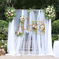 an outdoor wedding ceremony with white drapes and flowers