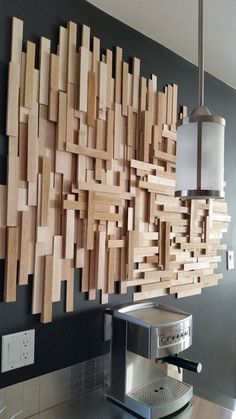 a coffee machine sitting on top of a counter next to a wall mounted wooden art