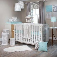 a baby's room is decorated in blue and gray colors with white accents on the walls