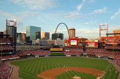 a baseball stadium with the st louis arch in the background