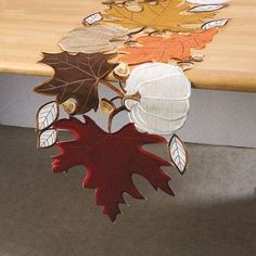 a wooden table topped with lots of leaves