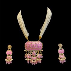 The Pink Rosho Set is an elegant and timeless piece. This beauty features Onyx beads with hydro beads on Kundan and Hand Painted Meenakari. Specifications Materials used: Brass with kundan hand painted meenakari Weight: Earrings 15 g, Necklace 118 g Lenght: Earrings 8 cm Necklace 38 cm At Romikas, we pride ourselves on the craftsmanship and high quality of our jewelry, designed to enhance your natural beauty. Please contact us with any questions. Traditional White Hand Painted Jewelry, Traditional Hand Painted Enamel Jewelry, Traditional Hand Painted Festive Necklaces, Pink Meenakari Jewelry For Ceremonial Occasions, Ceremonial Pink Meenakari Jewelry, Ceremonial Meenakari Enamel Jewelry, Festive Pink Jewelry With Dori Work, Pink Meenakari Jewelry For Eid, Traditional Jewelry Sets With Gota Work As Gift