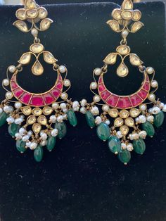 antique finish pure 92.5 silver chandbali earrings with semi precious emerald drops and ruby stones with pearls and kundan stones Jeweled Chandbali Temple Jewelry, Red Kundan Chandbalis In Fusion Style, Jeweled Silver Chandbalis For Festive Occasions, Festive Jeweled Silver Chandbalis, Festive Jeweled Chandbali Chandelier Earrings, Jeweled Chandbalis For Festivals, Traditional Jeweled Chandbalis For Diwali, Festive Jeweled Temple Jewelry Chandbalis, Bollywood Style Jeweled Chandbalis For Festivals