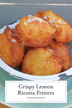 crispy lemon ricotta fritters in a white bowl on a blue plate