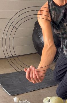 a man kneeling down in front of a sculpture