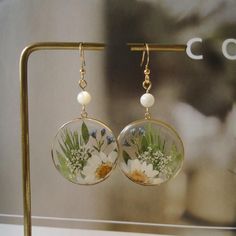 the earrings are decorated with flowers and leaves