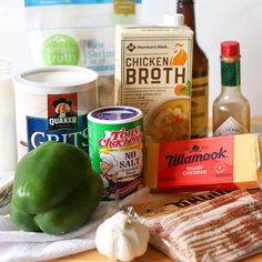 the ingredients for this dish are displayed on a cutting board, including green peppers, cheese, and other foodstuffs