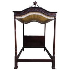 an antique wooden bed with intricate carvings on the headboard and foot board, made in england