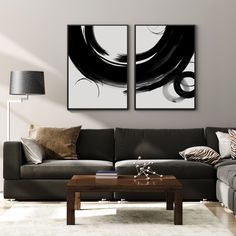 two black and white paintings in a living room