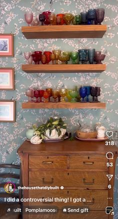 there are many glass bowls on the shelf above the dresser in this room, along with other items