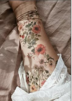 a woman's arm with flowers on it