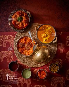 three bowls of food on a table with elephants in the background