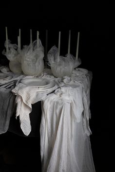 a table topped with lots of white cloth