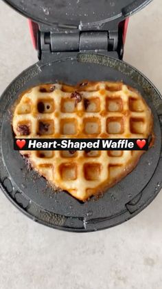 heart shaped waffle in a waffle maker on a counter top with the words heart - shaped waffle over it